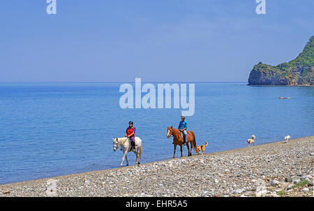 Horse riding at Psaropouli beach in the northeastern Evia, Aegean sea, Greece Stock Photo