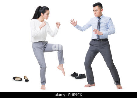 Businessman and businesswoman fighting Stock Photo