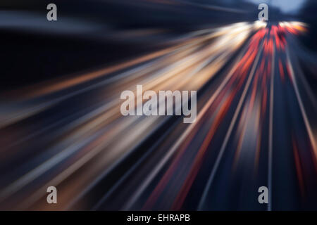 fast cars on highway in evening Stock Photo