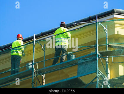 Men are working at the restoring of an old building Stock Photo