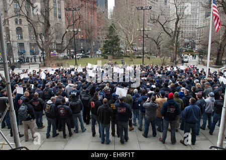 Manhattan, New York, USA. 16th Mar, 2015. Firefighters hold up signs as Uniformed Firefighters Association (UFA) President Stephen Cassidy leads a rally to address the FDNY's new discriminatory employment practices, City Hall, Monday March 16, 2015. © Bryan Smith/ZUMA Wire/Alamy Live News Stock Photo