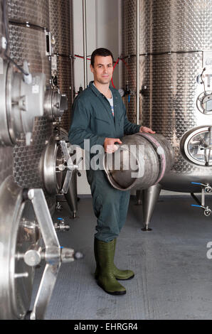 Staff Member holding Beer Barrel at the Hogs Back Brewery in Tongham Surrey Stock Photo