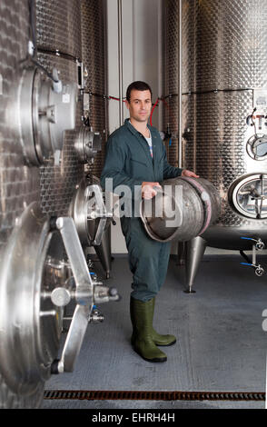 Staff Member holding Beer Barrel at the Hogs Back Brewery in Tongham Surrey Stock Photo
