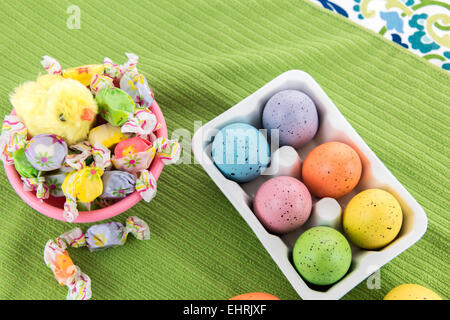 pastel colored Easter eggs, candy and a yellow spring chick Stock Photo