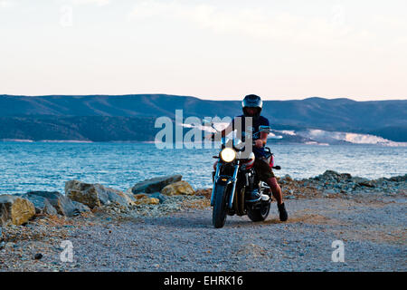 Man Driving Motocycle on the Pier in Croatia Stock Photo
