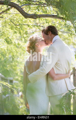 Young couple kissing in domestic garden Stock Photo