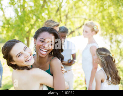 Bridesmaid and friend dancing during wedding reception in domestic garden Stock Photo