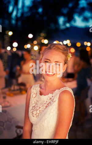 Portrait of bride in garden at dusk Stock Photo