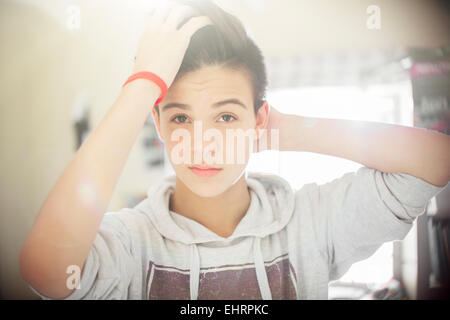 Portrait of teenage boy with hand in hair Stock Photo