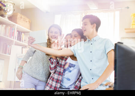 Teenagers taking selfie with digital tablet in room Stock Photo