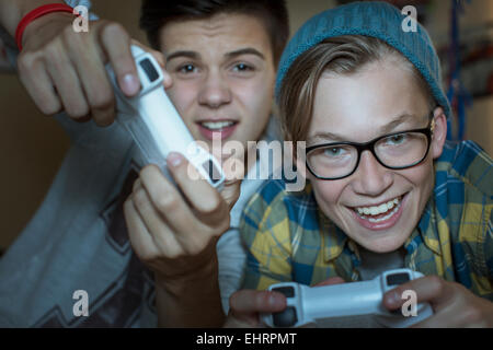 Two teenage boys playing together video game Stock Photo