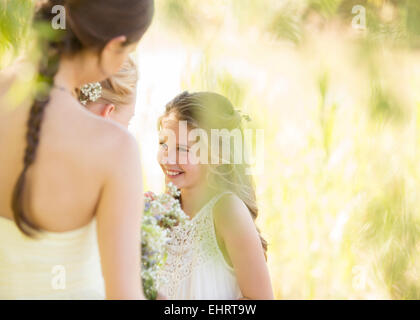 Bridesmaid with bouquet of flowers during wedding reception in garden Stock Photo