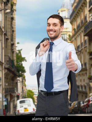 smiling young businessman showing thumbs up Stock Photo