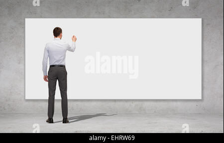 businessman writing with marker on white board Stock Photo