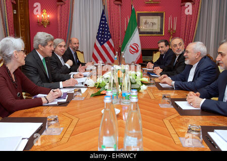 US Secretary of State John Kerry flanked by U.S. Under Secretary of State for Political Affairs Wendy Sherman, U.S.Energy Secretary Dr. Ernest Moniz, and National Security Council Senior Director for Iran, Iraq, Syria and the Gulf States Robert Malley, sit across from Iranian Foreign Minister Javad Zarif, Dr. Ali Akbar Salehi, the Vice President of Iran for Atomic Energy and President of the Atomic Energy Organization of Iran during talks on the future of Iran's nuclear program March 16, 2015 in Lausanne, Switzerland. Stock Photo