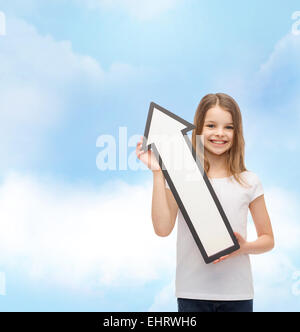 smiling little girl with blank arrow pointing up Stock Photo