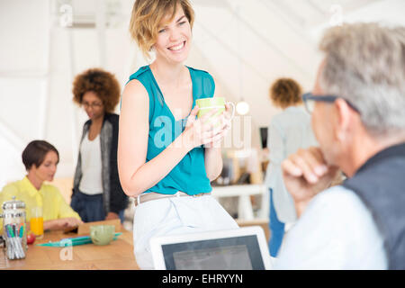 Office workers talking to each other during break Stock Photo