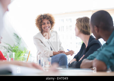 Office workers having meeting at desk Stock Photo