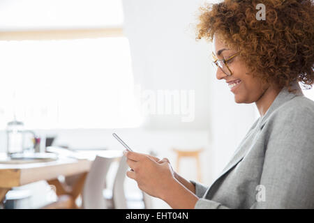 Portrait of woman using smart phone and smiling Stock Photo