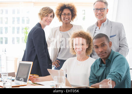 Portrait of office team smiling in conference room Stock Photo