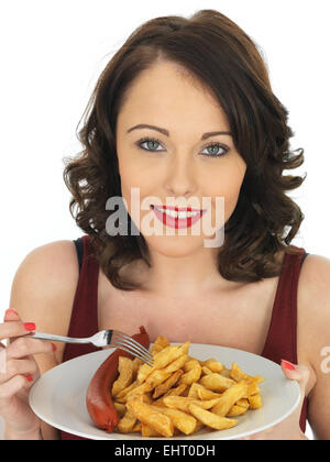 Confident Happy Young Woman Eating Authentic Chip Shop Takeaway Saveloy Sausage And Chips Isolated Against A White Background With A Clipping Path Stock Photo