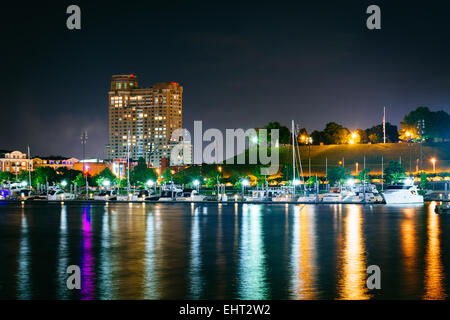 A marina and Federal Hill at night at the Inner Harbor in Baltimore, Maryland. Stock Photo
