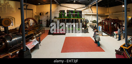 Visitors / tourists contemplate the power of the engines in the main hall at London Museum of Water & Steam. Brentford. UK. Stock Photo