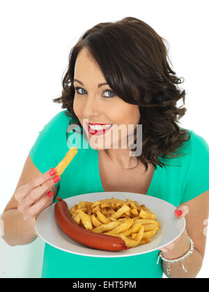 Confident Happy Young Woman Eating Authentic Chip Shop Takeaway Saveloy Sausage And Chips Isolated Against A White Background With A Clipping Path Stock Photo