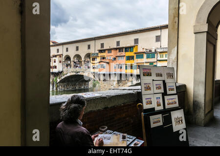 Florence,Italy-August 26,2014:one of the many street artists who painted the famous sights of Florence and then sell his works t Stock Photo