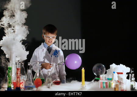 Smiling little scientist experimenting in lab Stock Photo