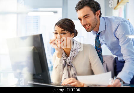 Man and woman working together in office Stock Photo
