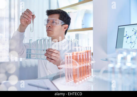 Man working in laboratory holding vile Stock Photo