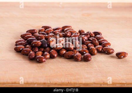 Borlotti beans dried ready for sowing, on wooden board Stock Photo