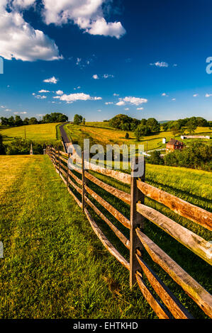 Fence and view of rolling hills and farmland in Antietam National Battlefield, Maryland (Vertical). Stock Photo