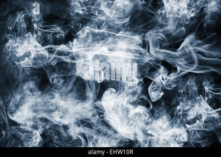 Fluffy Puffs of Smoke and Fog on Black Background Stock Photo