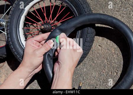 Man patching child's bicycle tire - USA Stock Photo