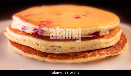Three American blueberry pancakes in a stack on a plate. Stock Photo