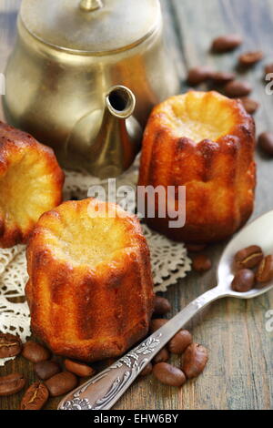Cake canneles and old coffee pot. Stock Photo