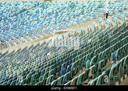 Durban, KwaZulu-Natal, South Africa, single adult man standing, empty colourful folding seats, Moses Mabhida Soccer Stadium, city, people, rows Stock Photo