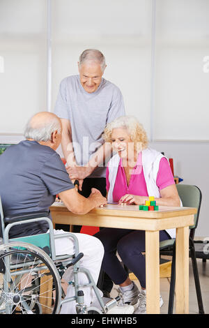 Happy senior people during rehab playing Bingo together Stock Photo