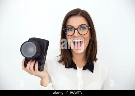 Surprised young businesswoman holding camera Stock Photo
