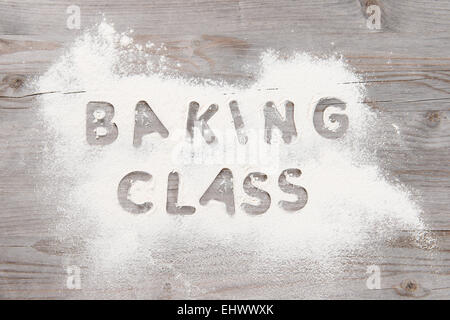 Baking classes poster design with flour on wooden table from overhead view. Stock Photo