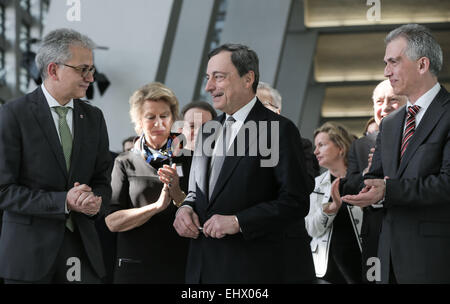 Hesse's Minister of Economy Tarek Al-Wazir (L), the president of the European Central Bank (ECB),  Mario Draghi (C) and Frankfurt's mayor Peter Feldmann (R) stand side-by-side during   the openinig ceremony of the ECB's new headquarter in Frankfurt, Germany, 18 March 2015. The opening ceremony took place amid widespread protests. Photo: FRANK RUMPENHORST/dpa Stock Photo