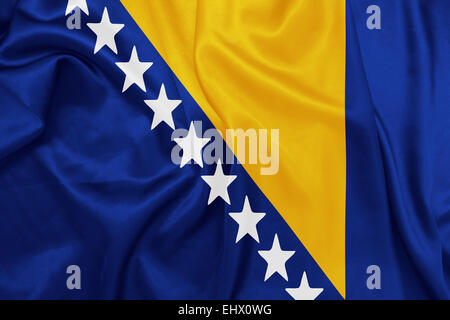 Bosnia and Herzegovina - Waving national flag on silk texture Stock Photo