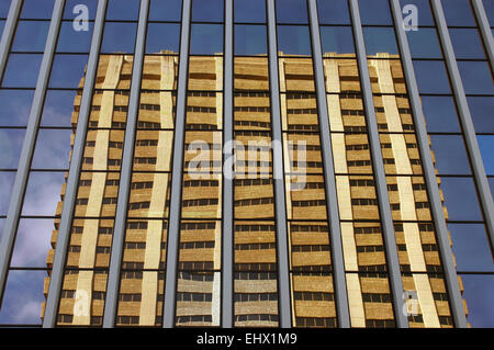 Modern architecture image of an office building reflected in the windows of another building Stock Photo