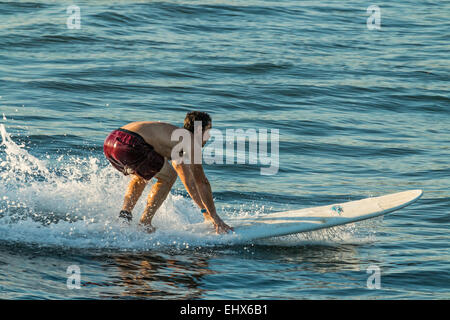 Surfer at Poneloya Beach, a popular little Pacific Coast resort west of the northern city of Leon; Poneloya, Leon, Nicaragua. Stock Photo