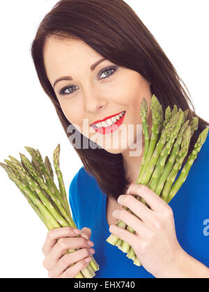 Attractive Young Woman Holding Fresh Asparagus Stock Photo