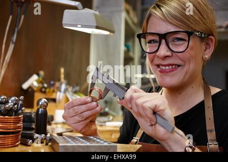 Portrait of goldsmith in workshop at work