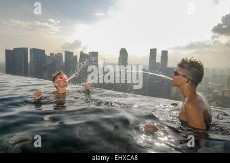 Teenage boys having fun at the pool, Marina Bay Sands, Singapore City, Singapore Stock Photo