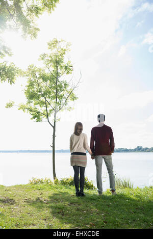 Couple holding hands lake shore romantic